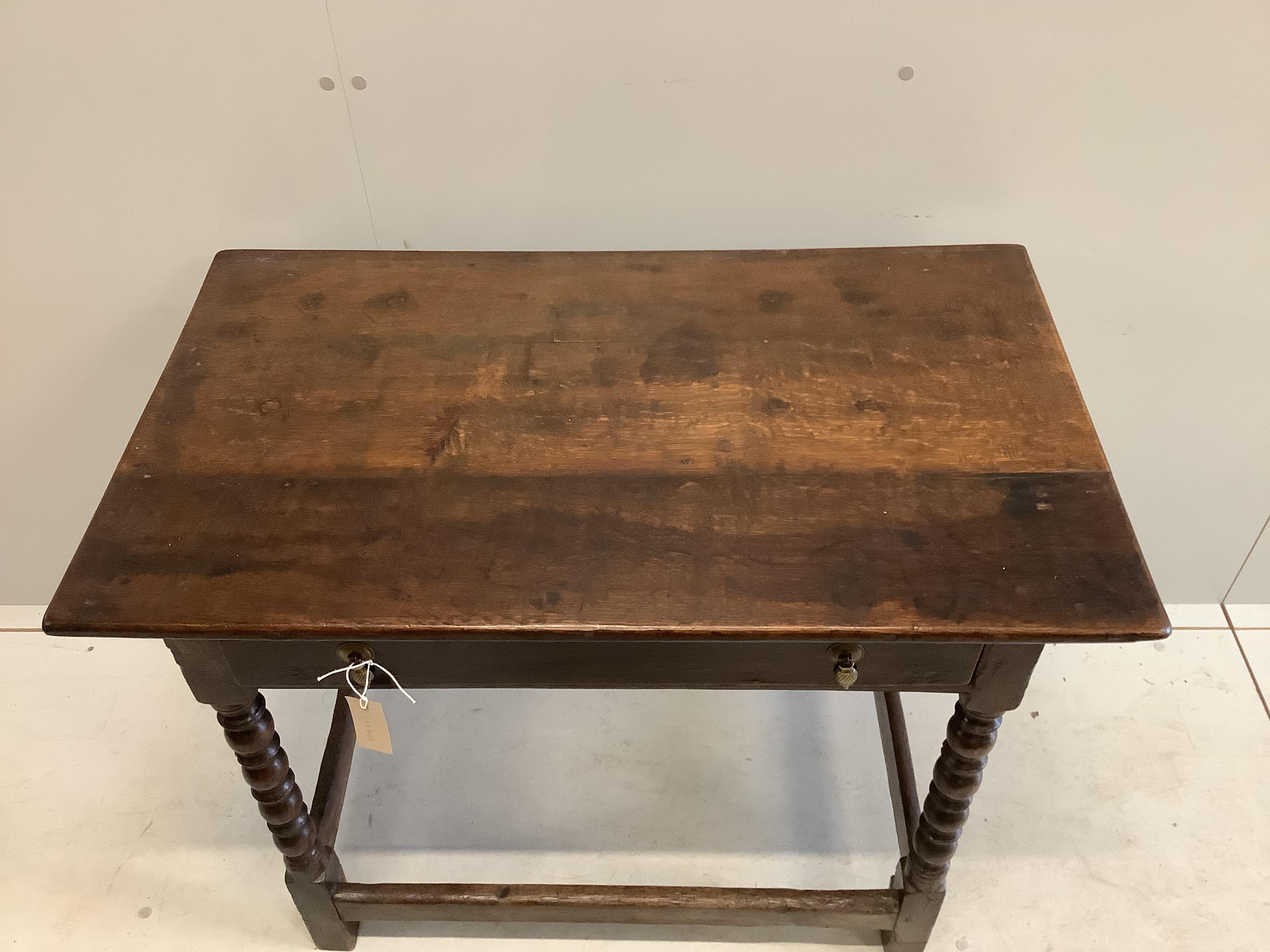 A 17th century Cromwellian rectangular oak single drawer bobbin leg side table, width 91cm, depth 54cm, height 71cm